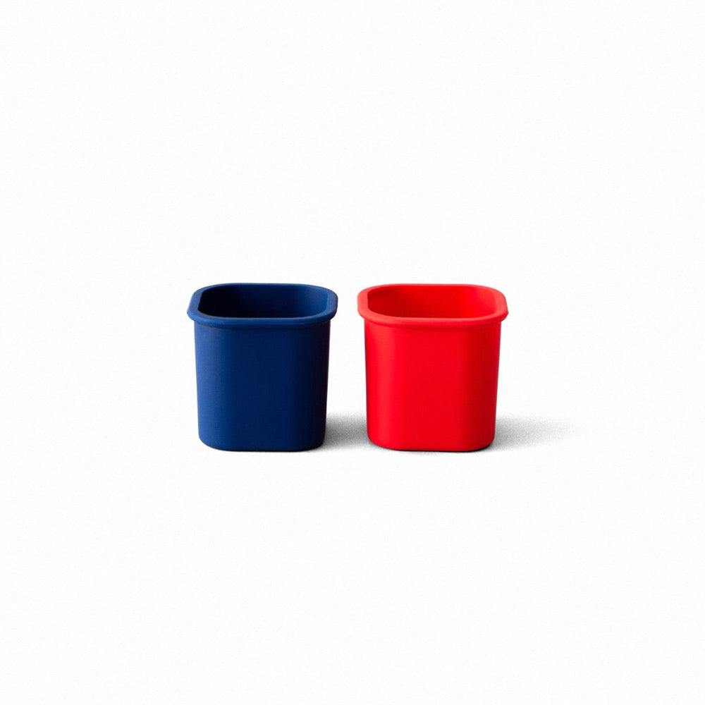 2 silicone snack pods that are meant to be used with planet box stainless steel lunchboxes - red and blue