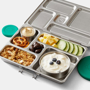 Packed breakfast, yogurt, granola, pretzels, hummus, cheese and cucumbers in rover planetbox zero-waste lunchbox